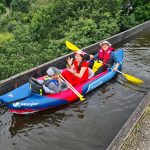A family in a kayak crossing the Pontcysyllte Aqueduct